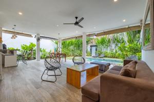 a living room with a couch and a table at Villas Shiva, Cahaya & Bulan Complex - Bingin, Uluwatu in Uluwatu