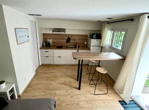 a small kitchen with a wooden table in a room at Le Studio nature de La Pra in Herbeys