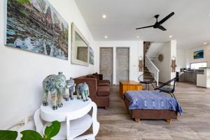 a living room with a couch and a table at Villas Shiva, Cahaya & Bulan Complex - Bingin, Uluwatu in Uluwatu