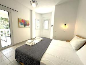 a bedroom with a bed with two towels on it at Enjoy Parga Appartments in Parga