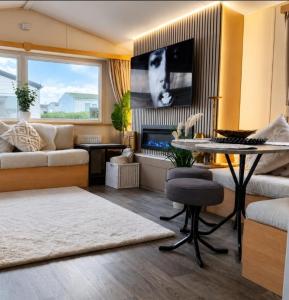 a living room with a table and a couch at Magnolia in Porthcawl