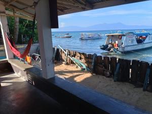 a view of the ocean from a house with boats in the water at Bunaken Blesshi Guest House in Bunaken