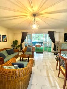 a living room with a couch and a table at Nenuphar 3 Bedroom-Apartment in Flic-en-Flac