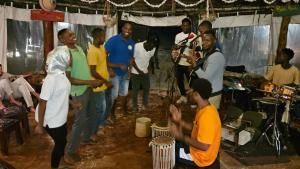 a group of people standing around in a room at Evergreen Bungalows in Bwejuu
