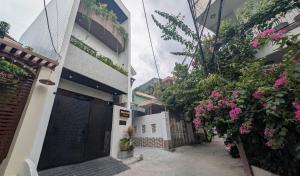 an alley with flowers on the side of a building at MONO HAUS Villa Danang in Danang