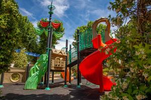 a playground with a red slide at Casa Rural La Posada del Quijote in Puerto Lápice