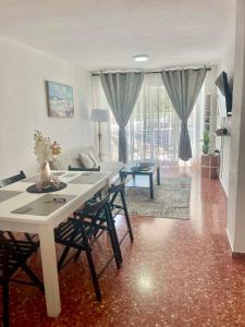 a living room with a table and chairs and a living room at Cataleya Apartment in Cullera