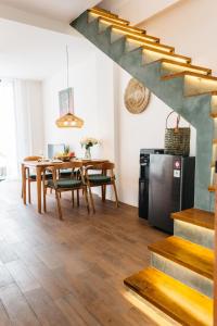 a kitchen and dining room with a table and a refrigerator at Santara Villa Ubud in Ubud