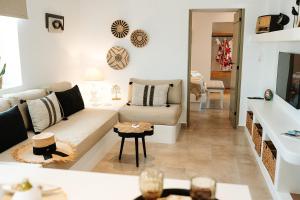a living room with a couch and a table at Naias View Home Milos in Adamantas