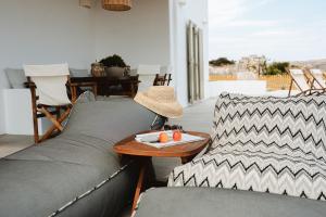 a living room with a couch and a table at Naias View Home Milos in Adamantas