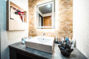 a bathroom with a sink and a mirror at Hotel M in Oyodo +68 photos