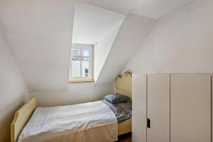 a small bedroom with a bed and a cabinet at Large Apartment 60 M² With Garden in Emmendingen