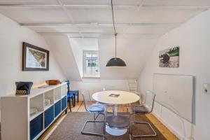 a kitchen with a table and chairs in a room at Large Apartment 60 M² With Garden in Emmendingen