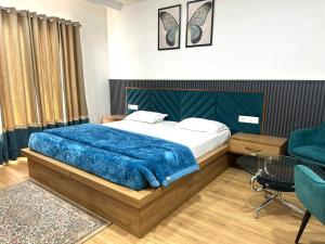 a bedroom with a bed and a table and chairs at K D Motels in Patiāla