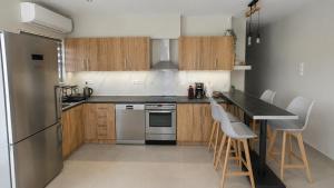 a kitchen with stainless steel appliances and wooden cabinets at Limera View Monemvasia in Monemvasia