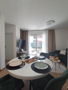 a living room with a table with food on it at Luxury Mint Garden Apartment in Kaštela