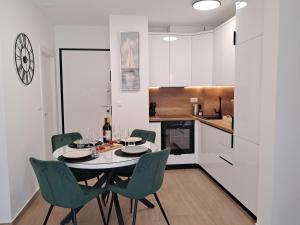 a dining room with a table and chairs in a kitchen at Luxury Mint Garden Apartment in Kaštela +42 photos