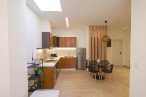a kitchen with a table and a dining room at Corali 1 - Coastal Retreat in Katakolo