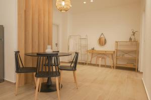 a dining room with a table and chairs at Corali 1 - Coastal Retreat in Katakolo