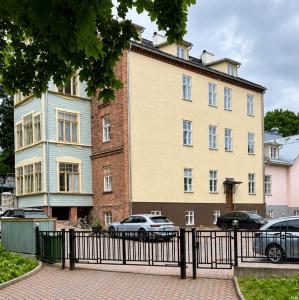 a large building with cars parked in front of it at Lossi 32 Lux Apartment in Tartu