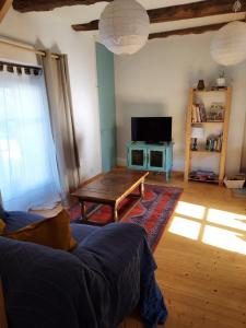 a living room with a couch and a table at Gîte Baumelin près de Dinan in Guenroc