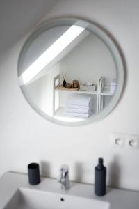 a mirror over a sink in a bathroom at Kralova Apartment in Modra in Modra +11 photos