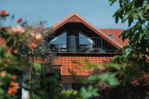 a house with a balcony on top of it at Kralova Apartment in Modra in Modra