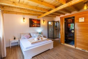 a bedroom with a bed and a glass shower at Villa Bali Oasis Grand Wellness in Stolac