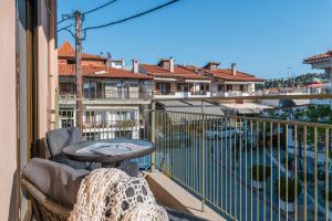 a balcony with a table and a view of a pool at Kripis Studio in Pefkochori