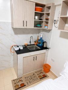 a kitchen with a sink and a kitchen rug at Phonex haven near Westside Mall in Nakuru