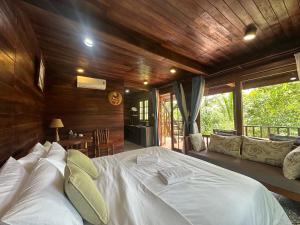a bedroom with a large white bed in a room at MK Hill resort Phu Quoc in Phú Quốc