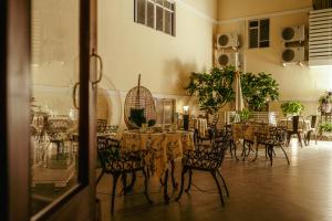a dining room with tables and chairs in a building at Broadway An Alivaa Collection Hotel, near Connaught Place in New Delhi +24 photos