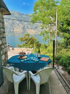 a table with a bottle of wine and two chairs at Stonehouse Kotor Bay in Kotor