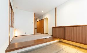 an empty room with a hallway with a wooden partition at GENPEI Guest House in Takamatsu