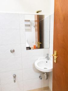 a bathroom with a sink and a mirror at Phonex haven near Westside Mall in Nakuru +7 photos