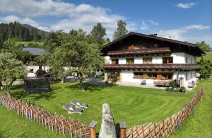 a house with a fence in front of a yard at Untergrundgut in Leogang
