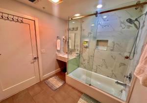a bathroom with a shower and a glass shower stall at The Classic Suite: 2BR close to NYC in Paterson +20 photos