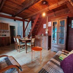 a kitchen and dining room with a table and chairs at Ostoja Lipiny in Sompolno