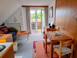 a living room with a table and a couch at Biker Hotel Harmonie in Bad Grund