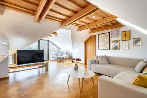 a living room with a couch and a tv at Kralova Apartment in Modra in Modra