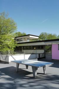 a ping pong table in front of a building at Sigma Self Check-in Hostel in Zurich