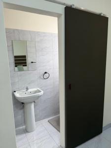 a bathroom with a sink and a mirror at Coastwave Guesthouse CBD in Walvis Bay +11 photos