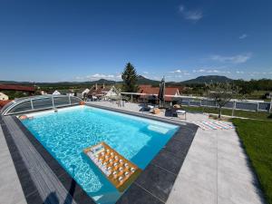 a swimming pool on top of a house at Dandelion Vendégházak in Kisapáti