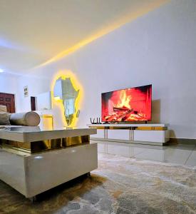 a living room with a flat screen tv on a wall at Entire Space T3 Centralidade do Kilamba, Luanda in Luanda