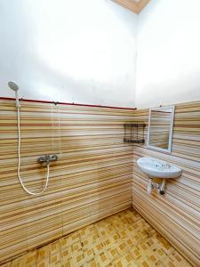 a bathroom with a sink and a shower at Kuta Garden in Kuta Lombok