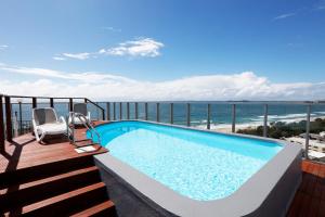 a swimming pool on a balcony with a view of the ocean at Majorca Isle Beachside Resort in Maroochydore