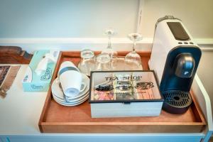a wooden tray with a hair dryer and wine glasses at Casa Baritiu Rooms in Braşov