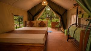 a bedroom with a bed in a tent at COCO FOREST CAMPING - Luxury Glamping & Villa - ONLY FOR FOREIGN BOOKINGS in Kurunegala