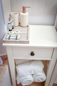 a white bathroom vanity with a sink and towels at Casa Baritiu Rooms in Braşov +62 photos