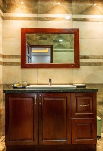 a bathroom with a sink and a mirror at Balcony Superior King - Châu Giang Hotel in Ga Phú Trung +22 photos